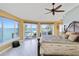 Serene main bedroom boasting water views and private access at 6119 Gnarled Oak Ln, Englewood, FL 34223