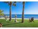 Relaxing waterfront lawn with lounge chairs and a lantern at 6119 Gnarled Oak Ln, Englewood, FL 34223