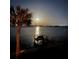 Night view of waterfront with dock and full moon at 6119 Gnarled Oak Ln, Englewood, FL 34223