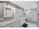 Elegant bathroom with double vanity and large walk-in shower at 15106 Meadowlake St, Odessa, FL 33556