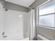 Simple bathroom with shower/tub combo and window at 15106 Meadowlake St, Odessa, FL 33556