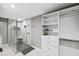 Bathroom with walk-in shower and built-in shelving at 15106 Meadowlake St, Odessa, FL 33556