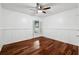 Cozy bedroom featuring hardwood floors and wainscoting at 15106 Meadowlake St, Odessa, FL 33556