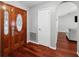 Hardwood floors, arched doorway, and elegant stained wood front door at 15106 Meadowlake St, Odessa, FL 33556