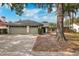 Two-car garage, mature landscaping, and a spacious front yard at 15106 Meadowlake St, Odessa, FL 33556