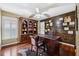 Home office with built-in wooden wall and hardwood floors at 15106 Meadowlake St, Odessa, FL 33556