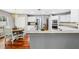 Eat-in kitchen with white cabinets, stainless steel appliances, and hardwood floors at 15106 Meadowlake St, Odessa, FL 33556