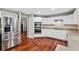 Modern kitchen with white cabinets, stainless steel appliances, and granite countertops at 15106 Meadowlake St, Odessa, FL 33556