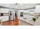 Modern kitchen with white cabinets, stainless steel appliances, and granite countertops at 15106 Meadowlake St, Odessa, FL 33556