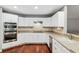 Modern kitchen with white cabinets, stainless steel appliances, and granite countertops at 15106 Meadowlake St, Odessa, FL 33556