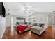 Spacious living room featuring hardwood floors and a large sectional sofa at 15106 Meadowlake St, Odessa, FL 33556