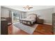 Main bedroom with hardwood floors and access to backyard at 15106 Meadowlake St, Odessa, FL 33556