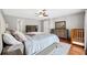 Main bedroom with hardwood floors and access to bathroom at 15106 Meadowlake St, Odessa, FL 33556