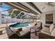 Relaxing pool area with covered patio and wicker furniture at 15106 Meadowlake St, Odessa, FL 33556