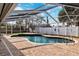Refreshing kidney-shaped pool with screened enclosure at 15106 Meadowlake St, Odessa, FL 33556