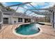 Large kidney-shaped pool with screened enclosure at 15106 Meadowlake St, Odessa, FL 33556