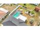 Overhead shot of screened in backyard pool, fenced yard, and manicured landscaping at 1720 Flamingo Ln, Sun City Center, FL 33573