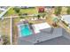Overhead aerial of fenced backyard, inground pool in screened enclosure and landscaping at 1720 Flamingo Ln, Sun City Center, FL 33573