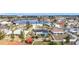 Wide aerial view shows a home with screened pool in a community near a waterway at 1720 Flamingo Ln, Sun City Center, FL 33573
