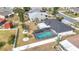 Aerial view of a home's backyard featuring a screened-in pool and fenced yard at 1720 Flamingo Ln, Sun City Center, FL 33573