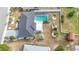 An aerial shot showcases a home with a screened-in pool and landscaped backyard at 1720 Flamingo Ln, Sun City Center, FL 33573