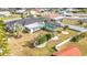 Beautiful backyard with a screened-in pool, well-manicured lawn, and decorative landscaping at 1720 Flamingo Ln, Sun City Center, FL 33573