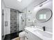 Modern bathroom featuring a stylish shower with black and white patterned tiles and a sleek vanity at 1720 Flamingo Ln, Sun City Center, FL 33573