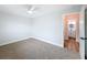Bedroom featuring neutral carpet, ceiling fan, and door leading to the bathroom at 1720 Flamingo Ln, Sun City Center, FL 33573