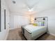 Clean bedroom featuring a white ceiling fan, carpet, and a large closet at 1720 Flamingo Ln, Sun City Center, FL 33573