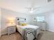 Bright bedroom featuring white furniture, plush carpet, and a ceiling fan at 1720 Flamingo Ln, Sun City Center, FL 33573