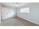 Bedroom featuring neutral carpet, ceiling fan, closet and a window with blinds at 1720 Flamingo Ln, Sun City Center, FL 33573