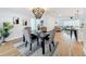 Open-concept dining area with a modern chandelier and wood-look flooring at 1720 Flamingo Ln, Sun City Center, FL 33573