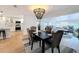 Dining area with modern lighting, hardwood floors, table seating for four adjacent to kitchen at 1720 Flamingo Ln, Sun City Center, FL 33573