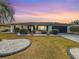 Charming home featuring a manicured front yard with decorative rock landscaping at 1720 Flamingo Ln, Sun City Center, FL 33573