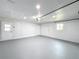 Large garage with painted floor, white walls and two entry doors to the house at 1720 Flamingo Ln, Sun City Center, FL 33573