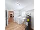 Bright laundry room featuring modern appliances, wash sink, and wood flooring at 1720 Flamingo Ln, Sun City Center, FL 33573