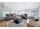 Sunlit living room featuring comfortable sofas and a view of the pool at 1720 Flamingo Ln, Sun City Center, FL 33573