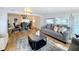 Bright living room with hardwood floors and open view to the dining room at 1720 Flamingo Ln, Sun City Center, FL 33573