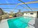 Backyard pool featuring a screen enclosure, a gray deck, and outdoor access at 1720 Flamingo Ln, Sun City Center, FL 33573