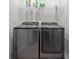 Laundry room with washer, dryer, and shelving at 2391 Summerlit St, Lutz, FL 33558