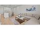Open living room with L-shaped sofa and modern coffee table at 2391 Summerlit St, Lutz, FL 33558