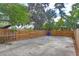 Large backyard with a wooden fence and a concrete patio at 3424 Queensboro S Ave, St Petersburg, FL 33711