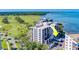 Aerial view of waterfront condo building with golf course and bay views at 6 Belleview Blvd # 105, Belleair, FL 33756