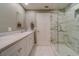 Bathroom with double vanity and a large shower at 6 Belleview Blvd # 105, Belleair, FL 33756