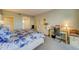 Comfortable bedroom with a king bed and built-in desk at 6 Belleview Blvd # 105, Belleair, FL 33756