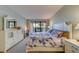 Spacious bedroom with king-size bed and patio access at 6 Belleview Blvd # 105, Belleair, FL 33756
