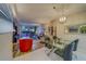 Bright dining area with glass table and modern chairs, open to living room and kitchen at 6 Belleview Blvd # 105, Belleair, FL 33756