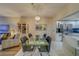 Elegant dining area with glass table and kitchen views at 6 Belleview Blvd # 105, Belleair, FL 33756