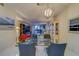 Open concept dining area with glass table and modern chairs at 6 Belleview Blvd # 105, Belleair, FL 33756