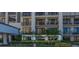 Condo building exterior showcasing ground floor units and landscaping at 6 Belleview Blvd # 105, Belleair, FL 33756